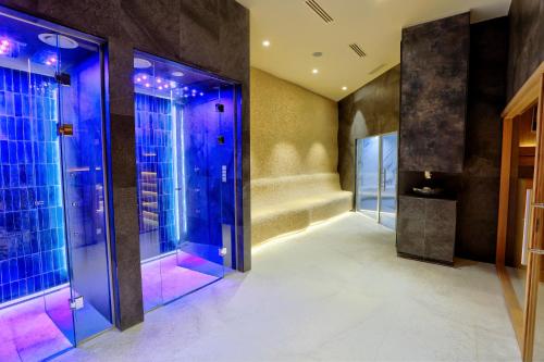 a lobby with blue and purple lighting and glass doors at Woodside Kopaonik 417-418 in Kopaonik