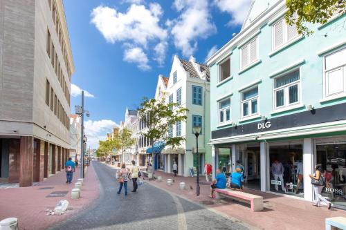a city street with people walking down the street at Punda City Centre Penthouse in Willemstad
