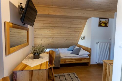 um quarto com uma cama e uma mesa num quarto em APLIT 2 GUEST HOUSE em Zakopane