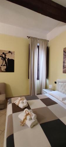 a bedroom with a bed with two towels on it at DIMORA AL SARACENO in Ferrara