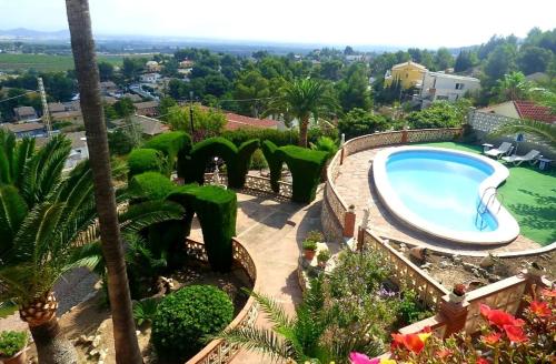 a large swimming pool in a yard with plants at Bella Vista House in Chiva