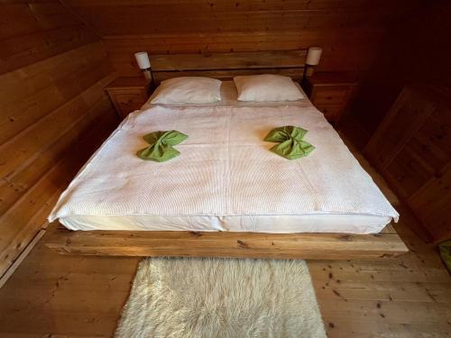 a bed in a wooden room with two pillows on it at Skigebiete Stuhleck und Semmering,Wandergebiete Schneeberg und Rax in Neunkirchen
