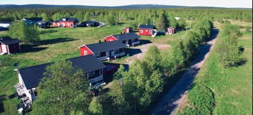 an aerial view of a farm with red buildings at Piilijärvi Camping in Gällivare
