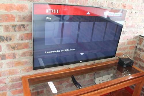 a flat screen tv sitting on a brick wall at Villa La F in Guasca