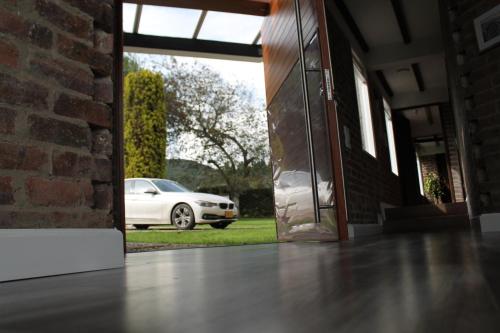 a white car is parked outside of a building at Villa La F in Guasca