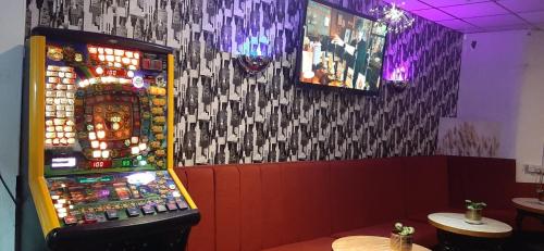 a room with a slot machine in a restaurant at PRESTIGE PLAZA Hotel in Blackpool