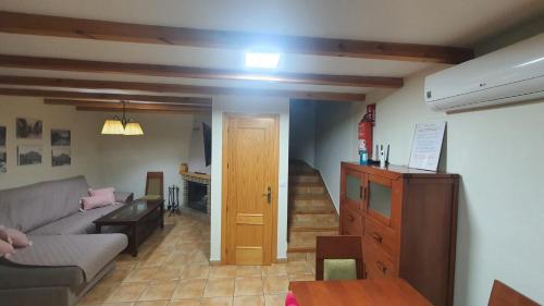 a living room with a couch and a stairway at Río Hereza in Arroyo Frio