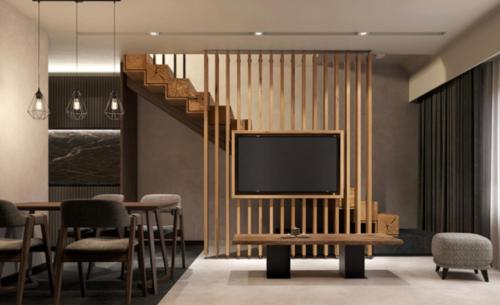 a living room with a television and a table and chairs at Woodside Duplex Apartment Ski in Ski out with garage in Kopaonik