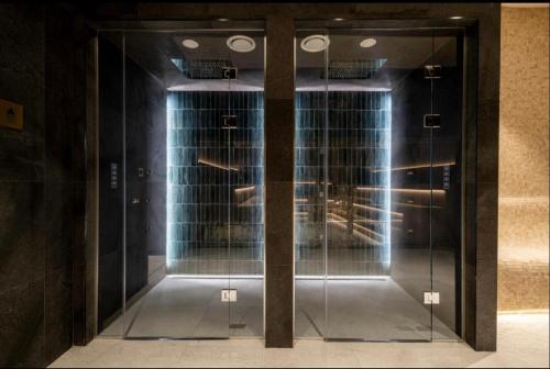 a room with glass doors in a building at Woodside Duplex Apartment Ski in Ski out with garage in Kopaonik