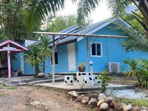 a blue house with two soccer balls in front of it at ทับศิลารีสอร์ท Tubsila Resort in Chongsadao