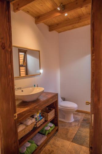 a bathroom with a sink and a toilet at Lodge Quelana in San Pedro de Atacama