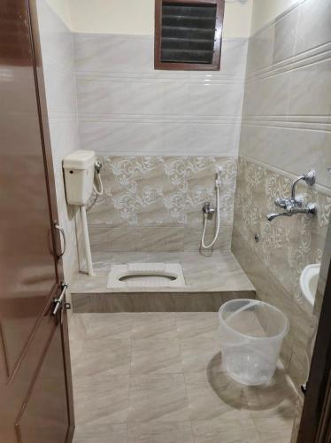 a small bathroom with a toilet and a sink at Home to explore Food, History & Shopping in Hyderabad