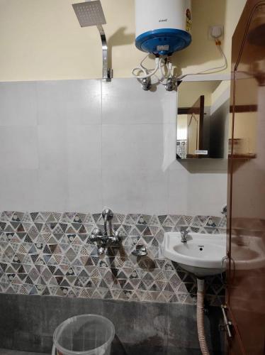 a bathroom with a sink and a mirror at Home to explore Food, History & Shopping in Hyderabad