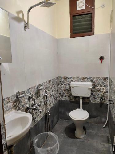 a bathroom with a toilet and a sink at Home to explore Food, History & Shopping in Hyderabad