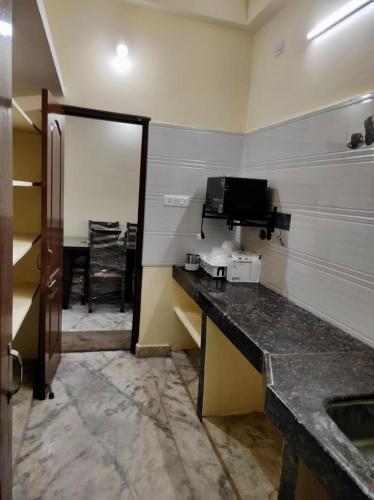 a room with a kitchen with a table and a mirror at Home to explore Food, History & Shopping in Hyderabad