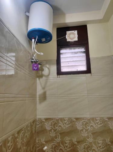 a bathroom with a blue light and a window at Home to explore Food, History & Shopping in Hyderabad