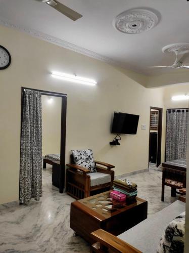 a living room with a couch and a tv at Home to explore Food, History & Shopping in Hyderabad