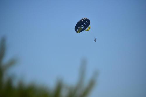 a person flying through the air in the sky at Happy Camp mobile homes in Camping Amadria Park Camping Trogir in Seget Vranjica
