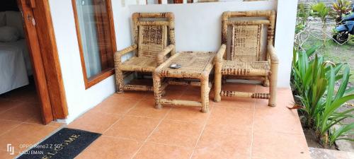 a table and chairs sitting on a porch at Ebucu in Kuta Lombok