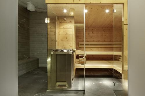 a glass shower in a bathroom with a sauna at Hotel Steffani in St. Moritz