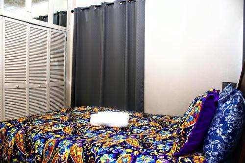 a bedroom with a bed with a blanket on it at Crystoural Apartment Liguanea Sovereign Apt - 2 Bedrooms, 3 Beds, Host 4 Guest- Kingston! in Kingston