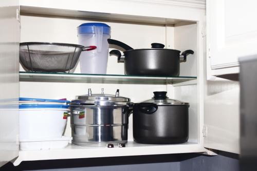 a shelf with pots and pans in a kitchen at Crystoural Apartment Liguanea Sovereign Apt - 2 Bedrooms, 3 Beds, Host 4 Guest- Kingston! in Kingston