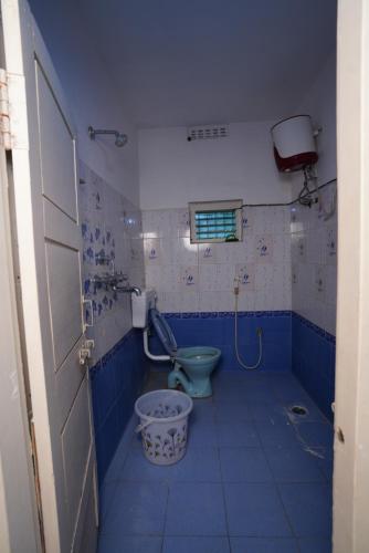 a bathroom with a blue toilet and a sink at Feel Like Home Rkbeach in Visakhapatnam