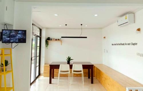 a dining room with a table and two chairs at Breezy Pattaya in Jomtien Beach