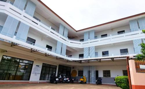 a large white building with two balconies on it at Breezy Pattaya in Jomtien Beach