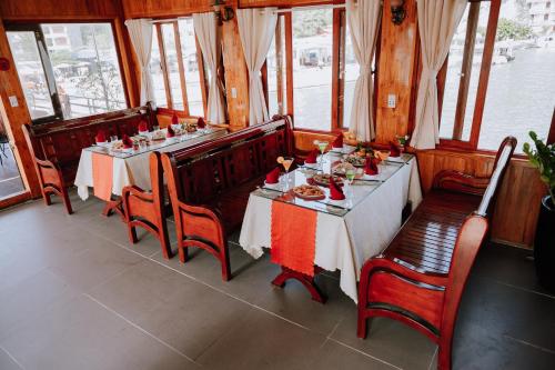 a dining room with a table with food on it at Cat Ba Bay Cruises in Cat Ba