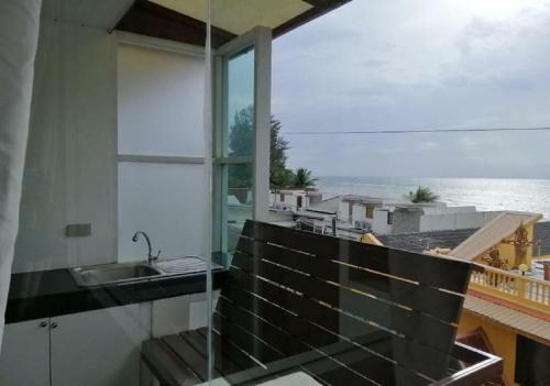 a balcony with a sink and a view of the ocean at Kamala View in Ban Huai Luk (1)