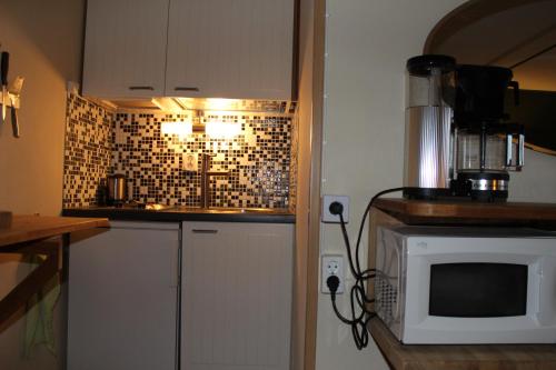 a kitchen with a microwave and a counter top at Hotel Borrby in Borrby