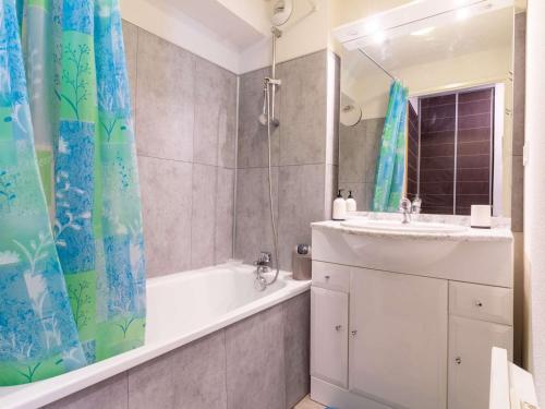 a bathroom with a tub and a sink and a shower at Agréable T2 Cabine avec Piscine, Balcon et WiFi à Luz-Saint-Sauveur - FR-1-402-116 in Luz-Saint-Sauveur
