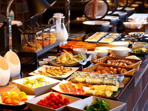 a buffet line with many different types of food at Grandvrio Hotel Beppuwan Wakura - ROUTE INN HOTELS - in Beppu