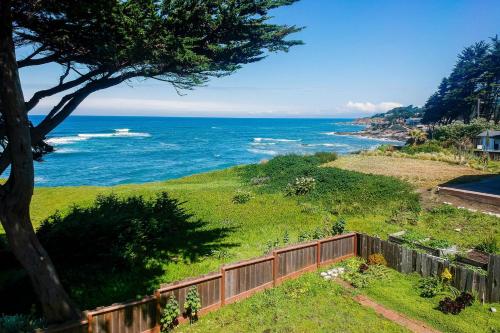 a view of the ocean from a fence at Oceanfront Home Retreat w Breathtaking Views of Fitzgerald Marine Reserve in Moss Beach