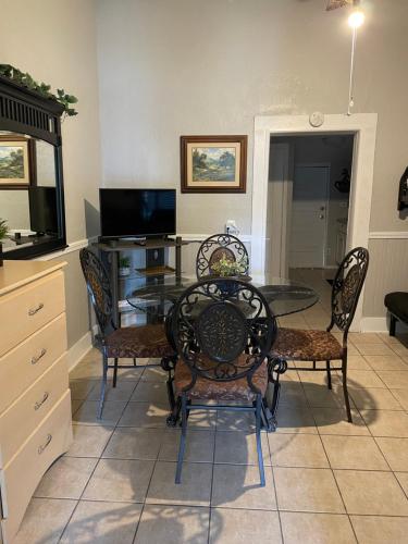 a dining room with a glass table and chairs at Downtown Heaven in San Antonio