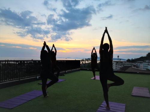 a group of people doing yoga on a roof at Panan Krabi Resort in Ao Nang Beach