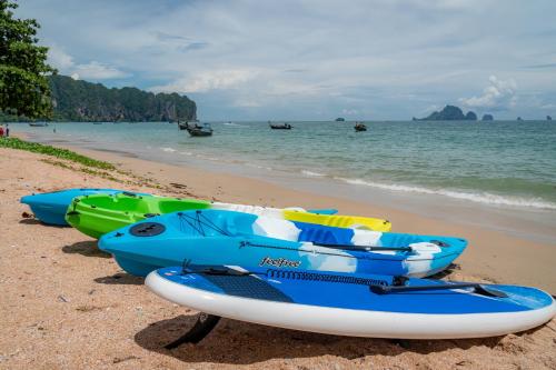 a group of boats sitting on the beach at Panan Krabi Resort - SHA Plus in Ao Nang Beach