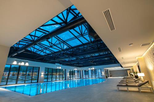 une grande piscine avec un grand plafond dans l'établissement Shabran Wellbeing Resort, à Pirǝbǝdil