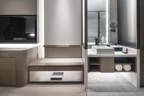 a bathroom with a sink and a mirror at The Barony Jinan East in Jinan