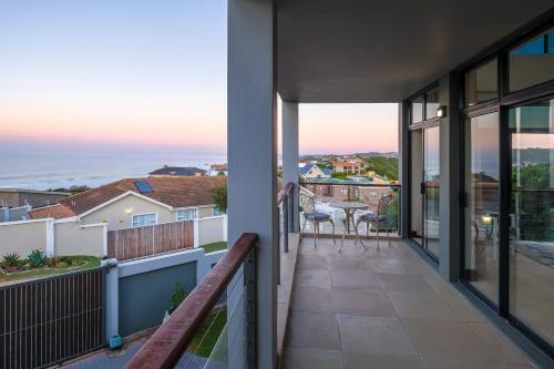 a balcony with views of the ocean from a house at Anchor's Haven Hersham in Groot Brak Rivier