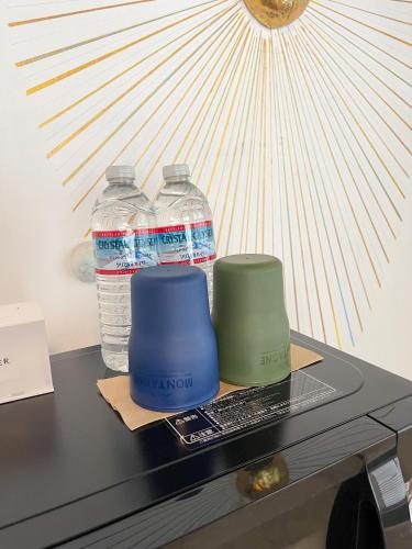 two bottles of water sitting on top of a desk at Kikusui Ryokan in Tamano