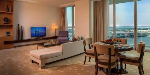 a living room with a couch and a dining room at InterContinental Residence Suites Dubai Festival City by IHG in Dubai