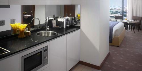 a kitchen with a sink and a bed in a room at InterContinental Residence Suites Dubai Festival City by IHG in Dubai