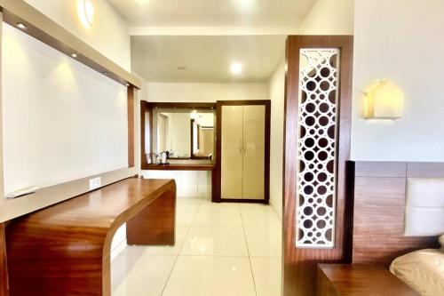 a living room with a large window and a hallway at Willo Stays Sea View Home Kannur Landsend in Kannur