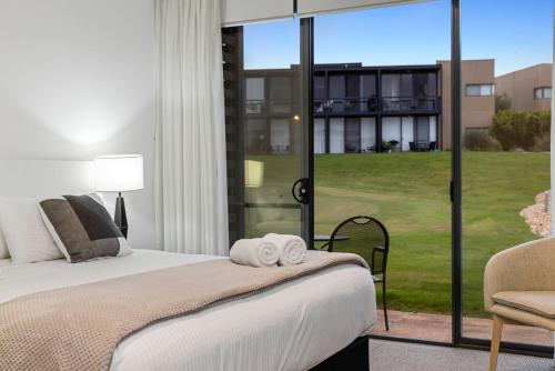 a bedroom with a bed and a view of a building at Relax at 54 in Fingal