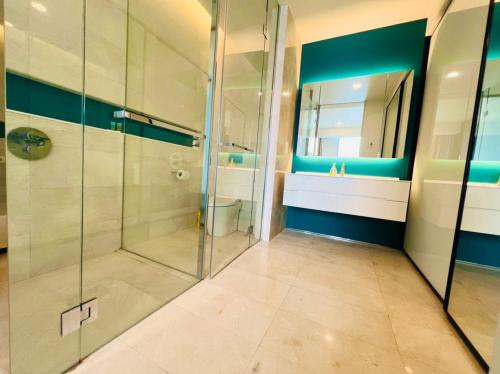 a bathroom with a shower and a toilet and a mirror at Tropicana The Residence KLCC By Rainbow Suites in Kuala Lumpur