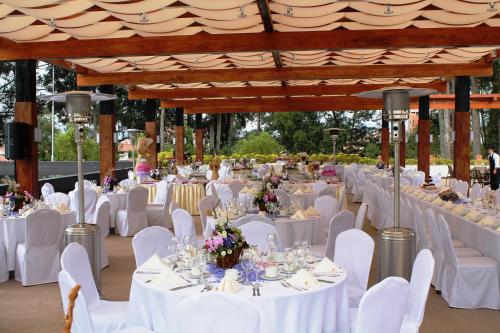 a banquet hall with white tables and white chairs at Oro Verde Cuenca in Cuenca