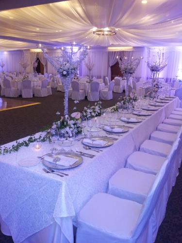 a long table with white tables and chairs in a marquee at Oro Verde Cuenca in Cuenca