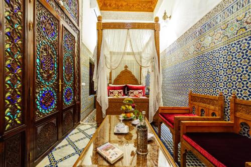a bedroom with a bed and a table with fruit on it at Riad Rcif & Spa Originale in Fès